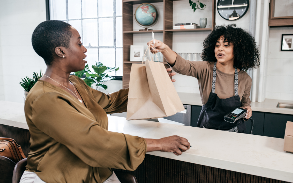POS Image Sales clerk handing a customer a bag